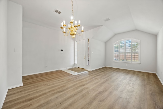 2402 Greenfield Cir, Garland, TX 75040 - unfurnished dining area with a chandelier, wood finished floors, baseboards, and lofted ceiling