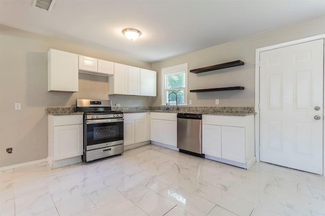 1610 Florence St, Arlington, TX 76010 - kitchen featuring stainless steel appliances, light stone counters, and light marble finish flooring