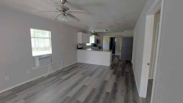 1107 Beech S, Bonham, TX 75418 - unfurnished living room featuring wood finished floors, a ceiling fan, cooling unit, and baseboards