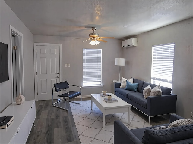 1107 Beech S, Bonham, TX 75418 - living area with an AC wall unit, ceiling fan, light wood-type flooring, and baseboards
