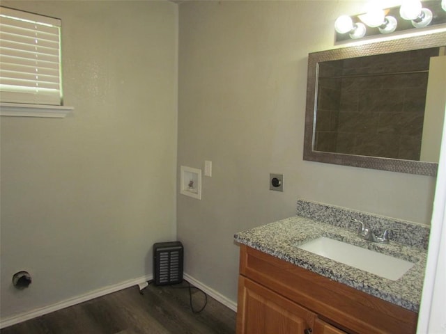 1107 Beech S, Bonham, TX 75418 - bathroom featuring wood finished floors, vanity, and baseboards