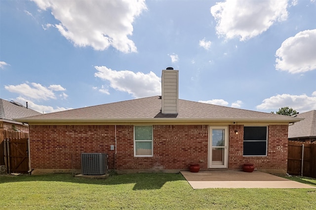 8115 Guadalupe Rd, Arlington, TX 76002 - back of property featuring central air condition unit, a patio area, a chimney, and brick siding