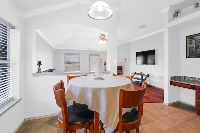 8115 Guadalupe Rd, Arlington, TX 76002 - dining room with ceiling fan, a fireplace, vaulted ceiling, light tile patterned floors, and baseboards