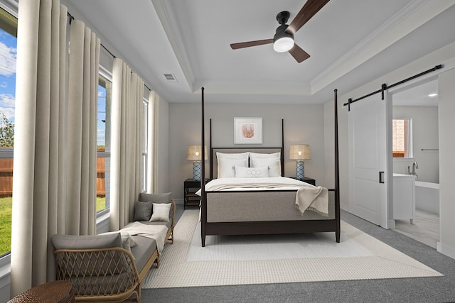 11549 Wulstone Rd, Fort Worth, TX 76052 - bedroom featuring a barn door, carpet, a tray ceiling, crown molding, and a ceiling fan