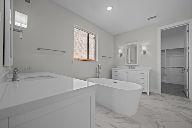 11549 Wulstone Rd, Fort Worth, TX 76052 - bathroom with marble finish flooring, vanity, a freestanding tub, a walk in closet, and recessed lighting