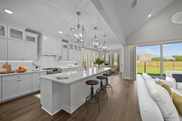 11549 Wulstone Rd, Fort Worth, TX 76052 - kitchen featuring a chandelier, stainless steel range with gas cooktop, tasteful backsplash, open floor plan, and an island with sink
