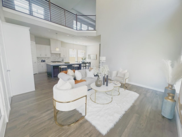 1002 Kennedy Dr, Allen, TX 75013 - living area featuring dark wood-type flooring, baseboards, and a towering ceiling