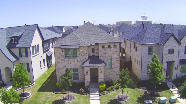 1002 Kennedy Dr, Allen, TX 75013 - view of front of property featuring brick siding, a front lawn, and a residential view