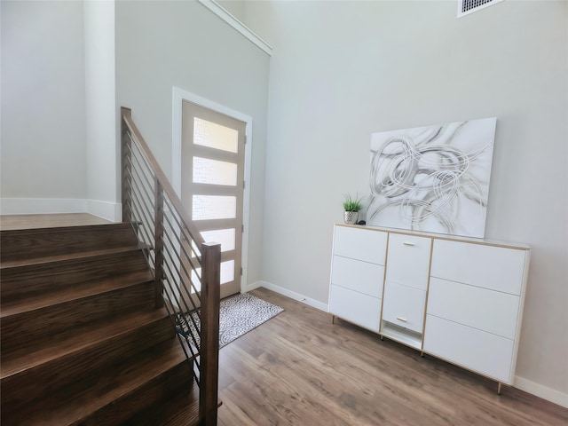 1002 Kennedy Dr, Allen, TX 75013 - entrance foyer with wood finished floors, baseboards, and stairs