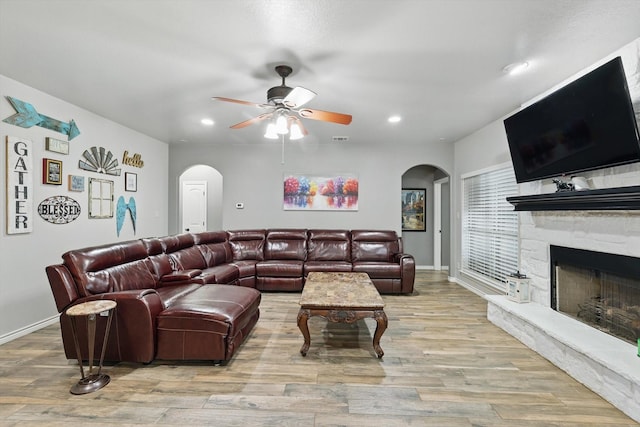 2210 Ridgewood Dr, Bridgeport, TX 76426 - living area featuring arched walkways, ceiling fan, wood finished floors, recessed lighting, and a fireplace