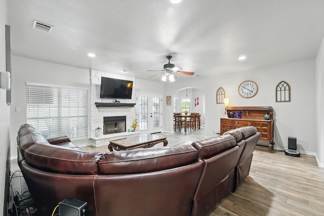 2210 Ridgewood Dr, Bridgeport, TX 76426 - living area featuring ceiling fan, baseboards, arched walkways, wood finished floors, and recessed lighting
