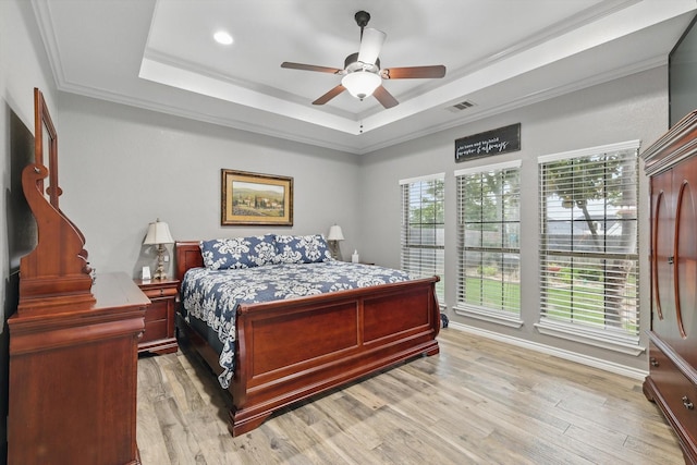 2210 Ridgewood Dr, Bridgeport, TX 76426 - bedroom with a raised ceiling, light wood finished floors, ceiling fan, crown molding, and baseboards