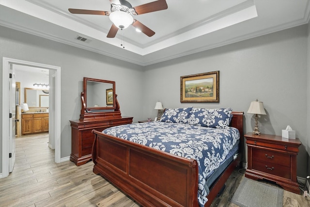 2210 Ridgewood Dr, Bridgeport, TX 76426 - bedroom with a tray ceiling, crown molding, light wood finished floors, ceiling fan, and baseboards