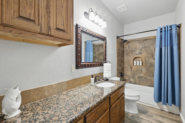 2210 Ridgewood Dr, Bridgeport, TX 76426 - bathroom featuring toilet, vanity, shower / bath combination with curtain, and wood finished floors