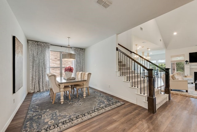 3594 Dover Dr, Mckinney, TX 75069 - dining room with stairway, wood finished floors, baseboards, a fireplace, and recessed lighting