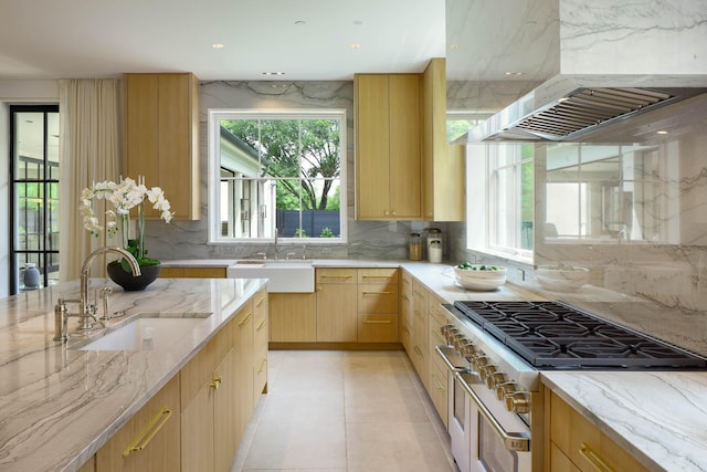 3906 Shenandoah St, Highland Park, TX 75205 - kitchen with double oven range, a sink, backsplash, and light stone counters