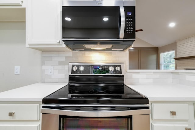 7300 Frances Ct, North Richland Hills, TX 76182 - kitchen featuring stainless steel appliances, decorative backsplash, white cabinets, light countertops, and vaulted ceiling
