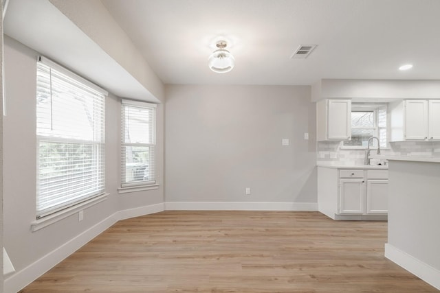 7300 Frances Ct, North Richland Hills, TX 76182 - unfurnished dining area with a sink, baseboards, light wood-style flooring, and recessed lighting