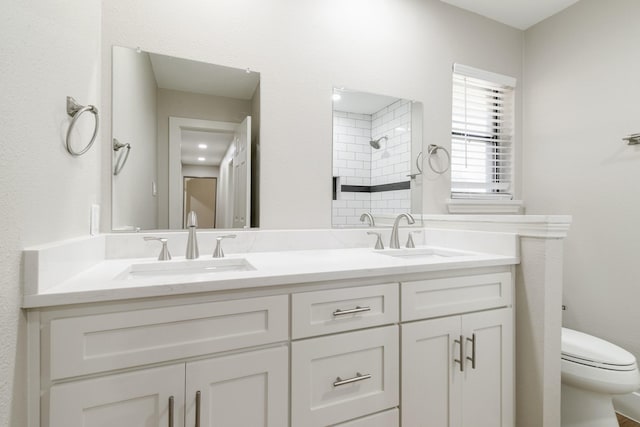 7300 Frances Ct, North Richland Hills, TX 76182 - bathroom featuring toilet, a tile shower, and double vanity