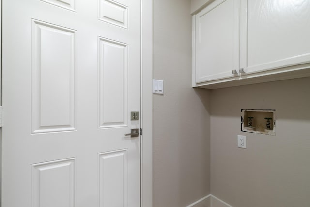 7300 Frances Ct, North Richland Hills, TX 76182 - laundry area featuring cabinet space, hookup for a washing machine, and baseboards