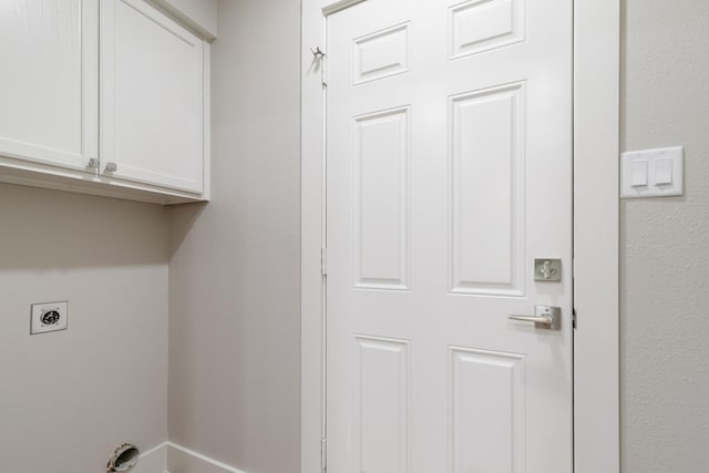 7300 Frances Ct, North Richland Hills, TX 76182 - laundry room featuring electric dryer hookup and cabinet space