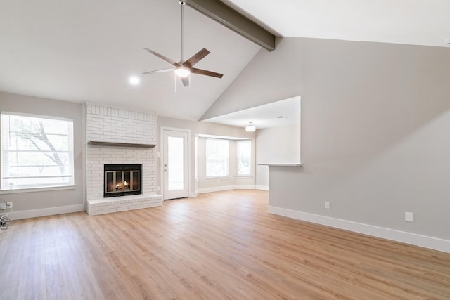 7300 Frances Ct, North Richland Hills, TX 76182 - unfurnished living room with a ceiling fan, beamed ceiling, a fireplace, light wood finished floors, and baseboards