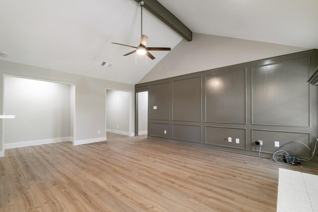 7300 Frances Ct, North Richland Hills, TX 76182 - unfurnished living room featuring a decorative wall, ceiling fan, beamed ceiling, light wood-style flooring, and high vaulted ceiling