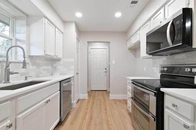 7300 Frances Ct, North Richland Hills, TX 76182 - kitchen with stainless steel appliances, a sink, decorative backsplash, white cabinetry, and recessed lighting