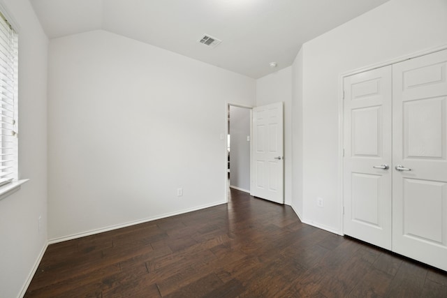 9712 Hedge Bell Dr, Mckinney, TX 75072 - unfurnished bedroom featuring wood finished floors, baseboards, a closet, and vaulted ceiling