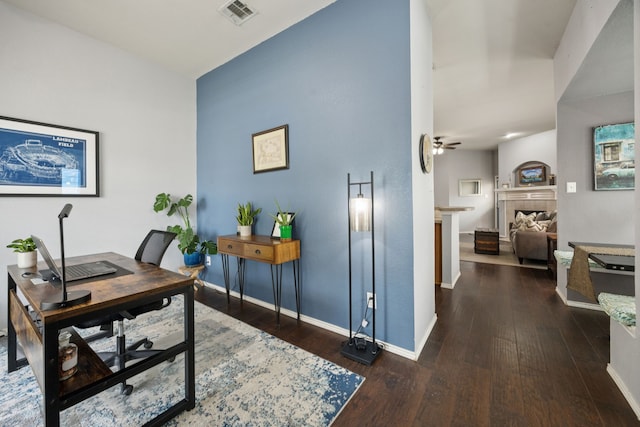 9712 Hedge Bell Dr, Mckinney, TX 75072 - office area featuring hardwood / wood-style flooring, baseboards, a ceiling fan, and a fireplace