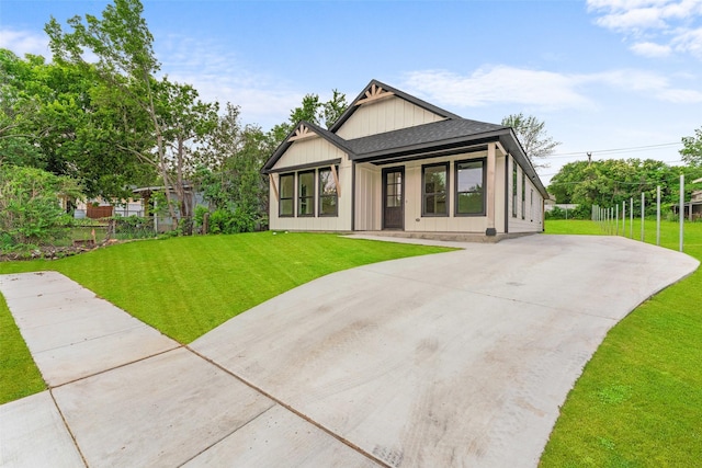 2915 NW Loraine St, Fort Worth, TX 76106 - rear view of property with concrete driveway, a lawn, and roof with shingles