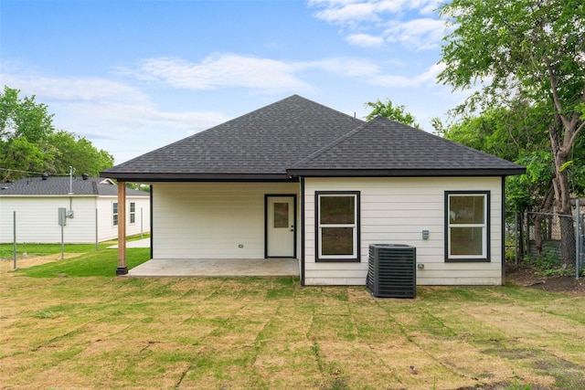 2915 NW Loraine St, Fort Worth, TX 76106 - back of property with roof with shingles, a patio area, and central air condition unit