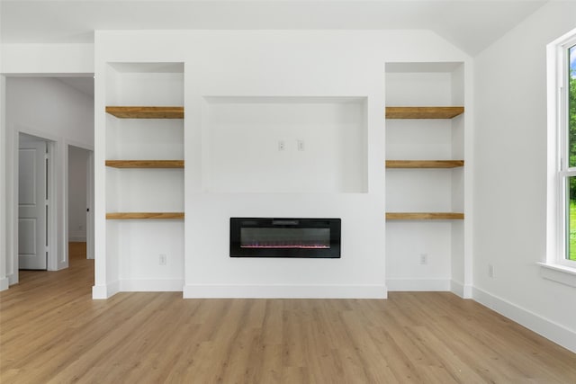 2915 NW Loraine St, Fort Worth, TX 76106 - unfurnished living room with a glass covered fireplace, light wood finished floors, built in shelves, and healthy amount of natural light