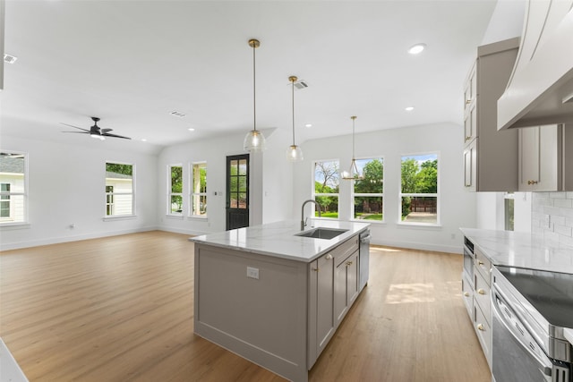 2915 NW Loraine St, Fort Worth, TX 76106 - kitchen featuring gray cabinetry, ventilation hood, a sink, light wood-type flooring, and baseboards