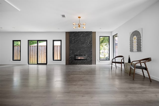 2535 Exline St, Dallas, TX 75215 - living area featuring a chandelier, wood finished floors, baseboards, and a high end fireplace