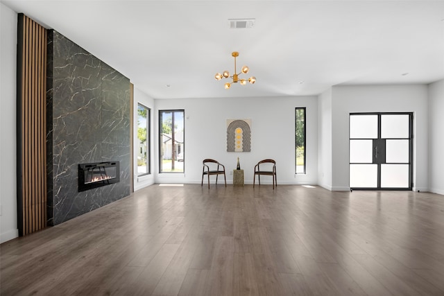 2535 Exline St, Dallas, TX 75215 - living room featuring wood finished floors, a fireplace, a chandelier, and baseboards