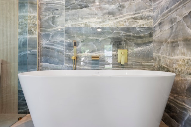 2535 Exline St, Dallas, TX 75215 - full bathroom with tile walls and a freestanding tub