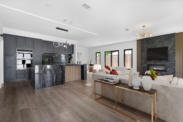 2535 Exline St, Dallas, TX 75215 - living room with dark wood-style flooring, a fireplace, a chandelier, and recessed lighting