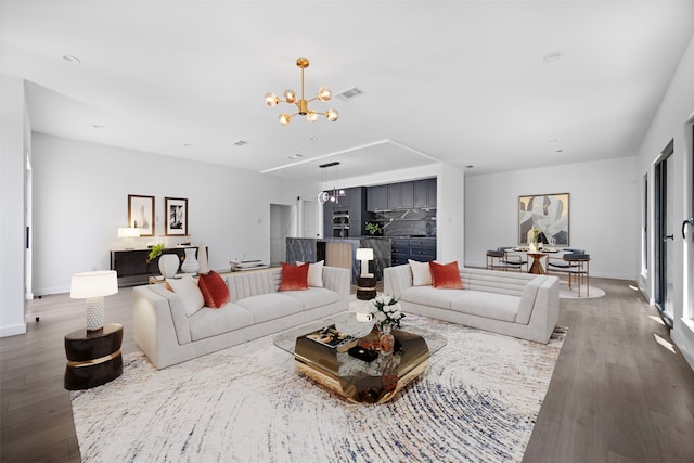 2535 Exline St, Dallas, TX 75215 - living room with a chandelier, wood finished floors, and baseboards