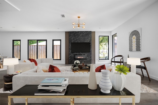 2535 Exline St, Dallas, TX 75215 - living room featuring dark wood-style floors, a chandelier, baseboards, and a premium fireplace