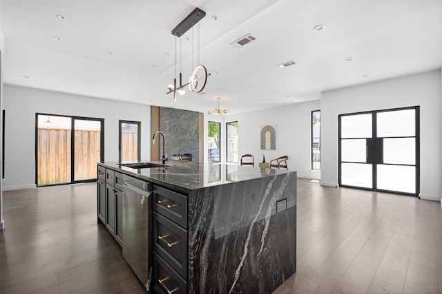2535 Exline St, Dallas, TX 75215 - kitchen with a sink, dishwasher, dark wood finished floors, open floor plan, and dark cabinets