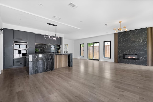 2535 Exline St, Dallas, TX 75215 - kitchen with open floor plan, a chandelier, dark wood-style flooring, a kitchen island with sink, and recessed lighting