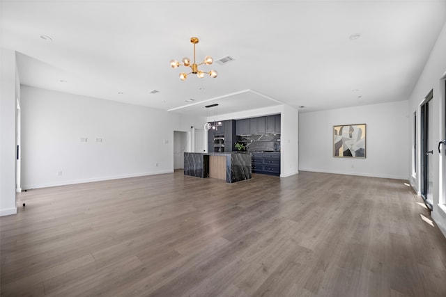 2535 Exline St, Dallas, TX 75215 - unfurnished living room with a chandelier, wood finished floors, and baseboards