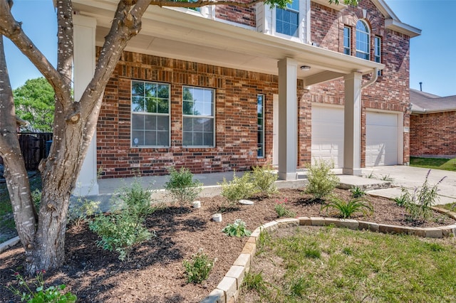 9316 Norfolk Ln, Mckinney, TX 75071 - view of front of property featuring brick siding, driveway, a garage, and covered porch