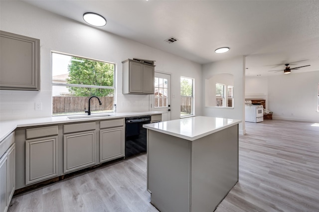 9316 Norfolk Ln, Mckinney, TX 75071 - kitchen with gray cabinetry, a sink, black dishwasher, white gas range, and backsplash