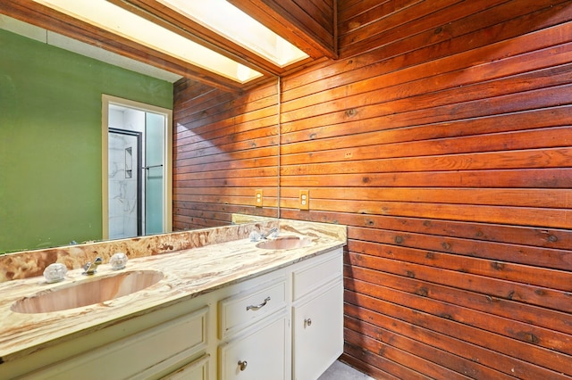full bath with wooden walls, a shower stall, double vanity, and a skylight