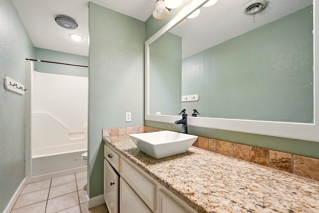 full bathroom featuring vanity, tile patterned floors, toilet, baseboards, and shower / washtub combination