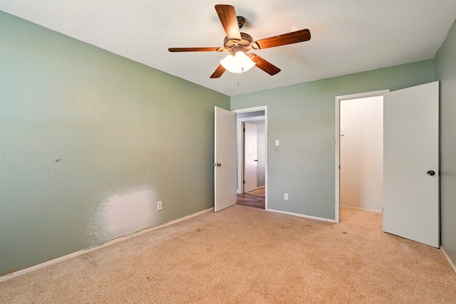 unfurnished bedroom with carpet floors, baseboards, and a ceiling fan