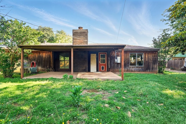 back of property with a patio area and a chimney