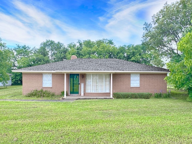 303 Luby Dr, Tom Bean, TX 75489 - ranch-style house featuring a front yard, brick siding, and a chimney
